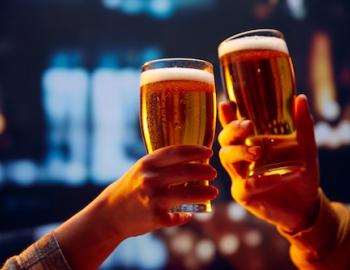 Clicking beer glasses together in a toast