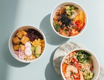 three poke bowls on a table