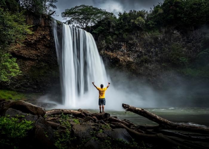 man at a waterfall in Hawaii