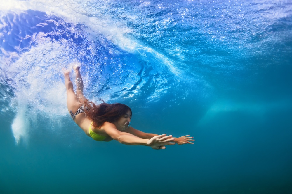 Woman swimming underwater.